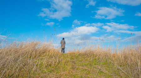 Woman on a dike in winterの写真素材