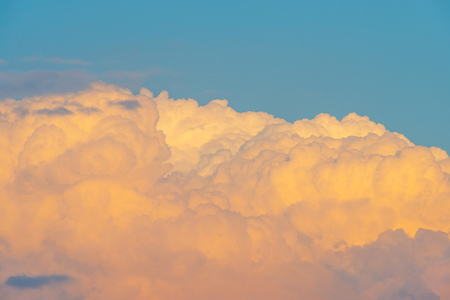 Clouds in a blue sky at sunrise in spring