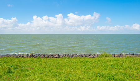 Dike along a lake in springの写真素材