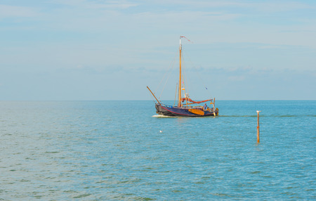 Sailboat sailing on a lake in sunlight in summerの写真素材