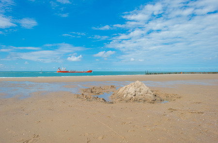 Sandy beach along a sea in sunlight in summerの写真素材