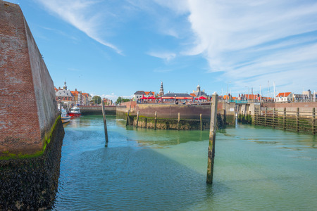 Harbor of a city below a blue cloudy sky in summerの写真素材