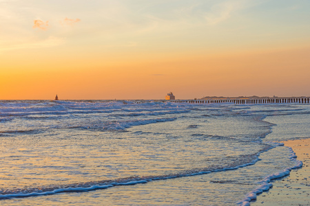 Sea along a sandy beach in the light of sunset in summerの写真素材