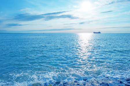 Sea along a sandy beach in the light of sunset in summerの写真素材