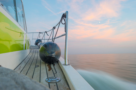 Sailing fast in the smooth water of a lake at sunset