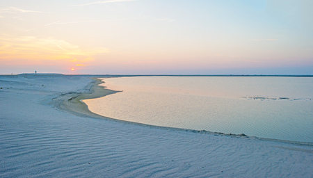 Artificial island under construction in a lake at sunset in summerの写真素材