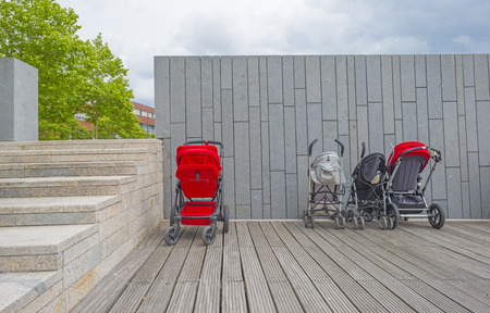 Buggies parked in line on a jetty against a wall