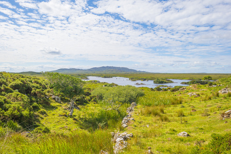 View of the meadows, lakes and mountains of the region Connemara in Irelandの写真素材