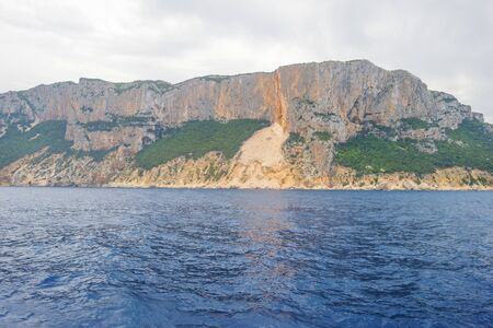 Rocky coast of the island of Sardinia in the Mediterranean Sea viewed from a boatの写真素材