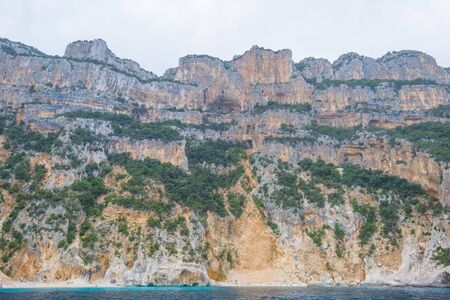 Rocky coast of the island of Sardinia in the Mediterranean Sea viewed from a boatの写真素材