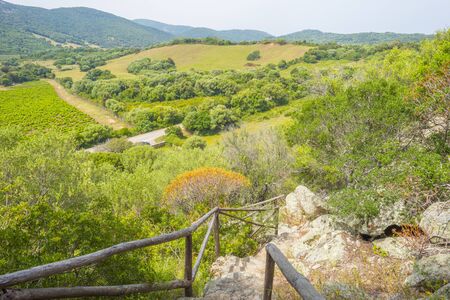 Scenic landscape or green hills and rocky mountains or the island of Sardinia in springの写真素材