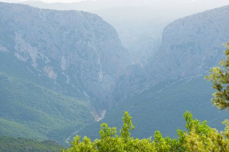 Scenic landscape or green hills and rocky mountains or the island of Sardinia in spring