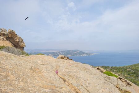 Rocky coast of the island of Sardinia in the Mediterranean Sea in sunlight in spring