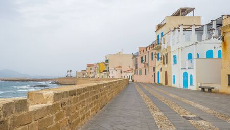 View of parts of the Sardinian town of Alghero along the Mediterranean Sea in springの写真素材