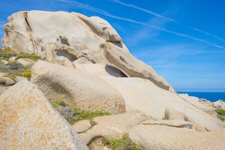 Rocky coast of the island of Sardinia in the Mediterranean Sea in sunlight in spring