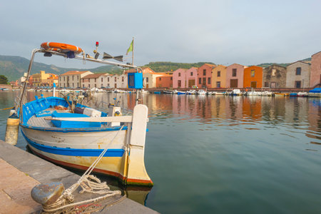 Panorama of the colorful town of Bosa along a river and hills in sunlight in springのeditorial素材