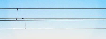 Overhead line in a blue sky as part of an electric railway system for transmitting electrical power...