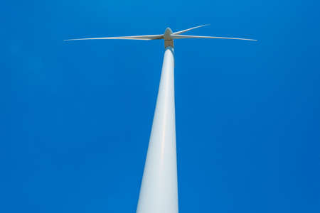 Wind turbines for renewable energy in bright blue sunlight in springtime, Almere, Flevoland,...