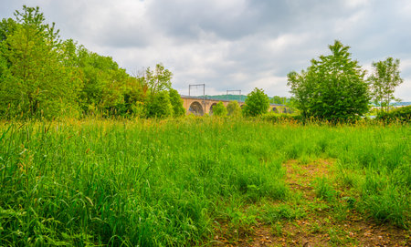Old railway bridge over a meadow in the countryside of Bavariaの写真素材