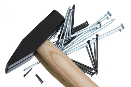 macro of hammer and nails with mirror reflection