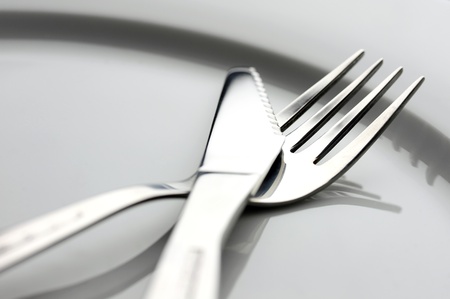 table knife and fork over plate 