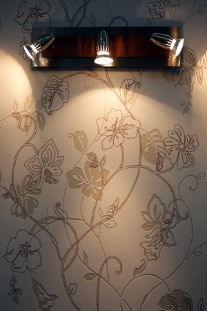 three spoted wall lamp on wallpaperの写真素材