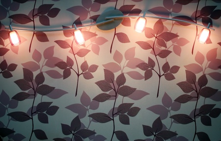 spotted wall lamp on wallpaperの写真素材