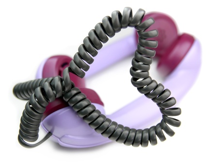 two telepfone receiver connected each other with heart shape phone cord の写真素材