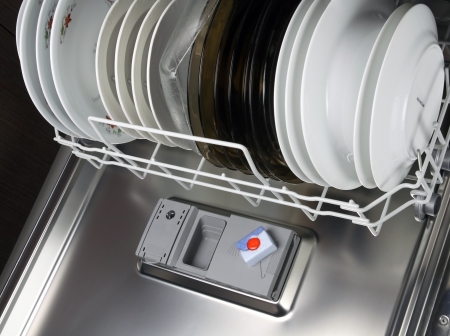 open dishwasher with clean plates in it, focus on tabs dishwasher tabsの写真素材
