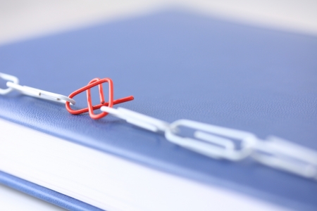 Red heart shape paper clip in white clips lineの写真素材