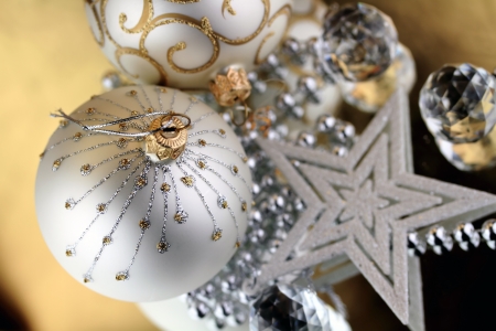 Two Christmas baubles, Cristal sphere and star golden background with reflectionsの写真素材