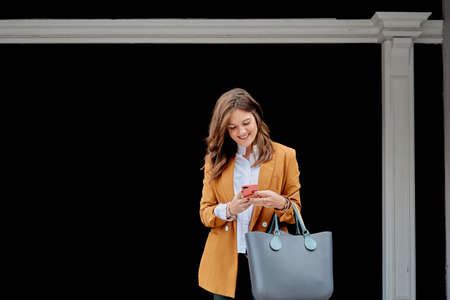 Woman sending a message with your mobile phoneの写真素材