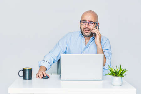 A self-employed entrepreneur working from home with a laptop. Adult bald manの写真素材