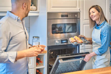 Couple preparing cupcakes. Couple cooking at home. Pastry conceptの写真素材