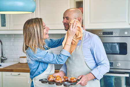 Couple preparing cupcakes. Couple cooking at home. Pastry conceptの写真素材