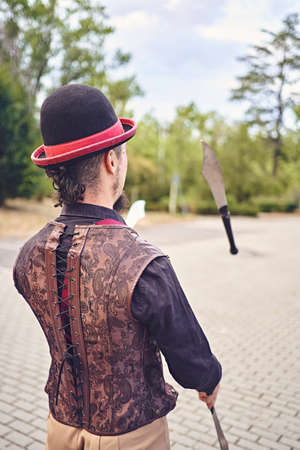 Man juggling knives in parkの写真素材