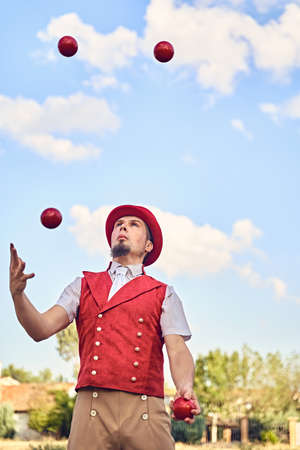 Man juggling balls in parkの写真素材