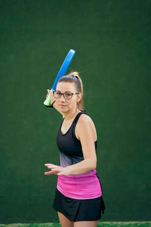 Sportswoman swinging racket during match