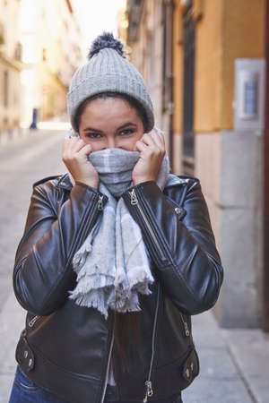 Trendy female adjusting warm scarfの写真素材