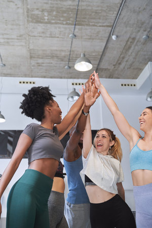 Group of sporty people celebrating after training together in the gym. Sport and healthy lifestyle concept.の写真素材