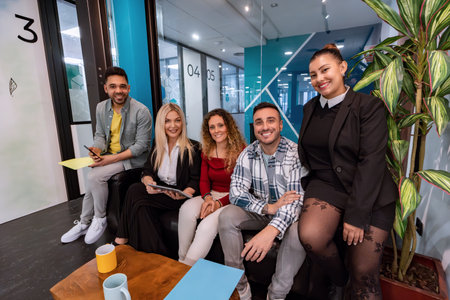 Business people smiling while posing together in the office. Business concept.