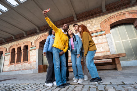 Group of multiethnic friends taking selfies with a mobile phone. Technology and friendship concept.