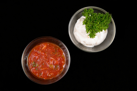Sauces in bowls on black background, top viewの写真素材