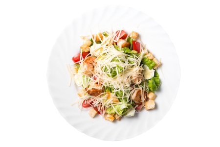 Caesar salad with prawns, cherry tomato and cheese on white plate, isolatedの写真素材