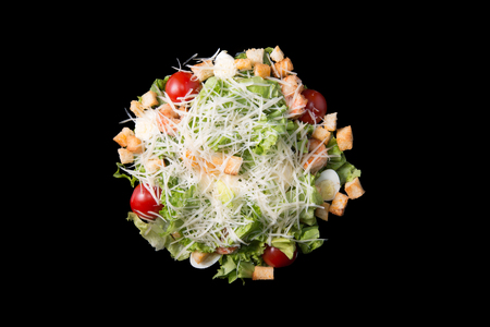 Caesar salad with prawns, cherry tomato and cheese, isolatedの写真素材