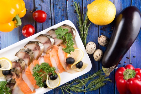 Fresh vegetables and slices fish on wooden background, top viewの写真素材