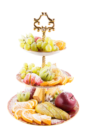 Slices fresh fruit into a three-tiered glass vase isolatedの写真素材