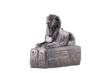 Statuette of the Egyptian sphinx made of stone on a white backgroundの写真素材