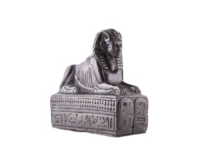 Statuette of the Egyptian sphinx made of stone on a white backgroundの写真素材