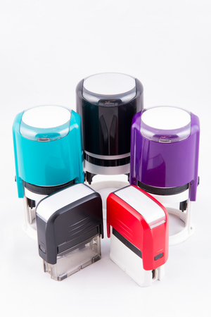 Automatic hand-stamps different colours on white backgroundの写真素材